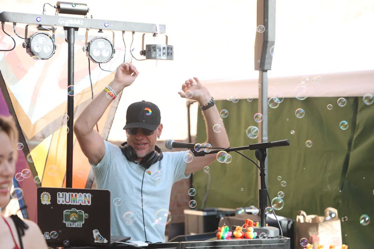 DJ Smilin' Jack behind the booth as bubbles fill the air